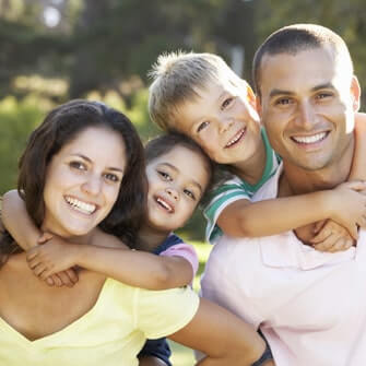A smiling family with healthy smiles, thanks to family dentistry